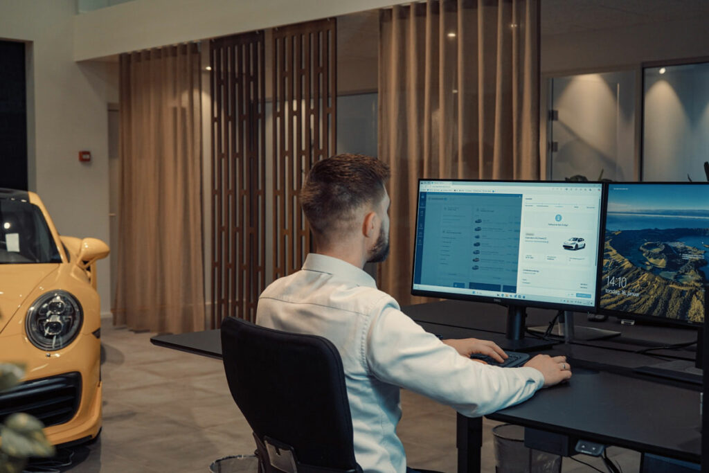 a man sitting at a desk working on a computer
