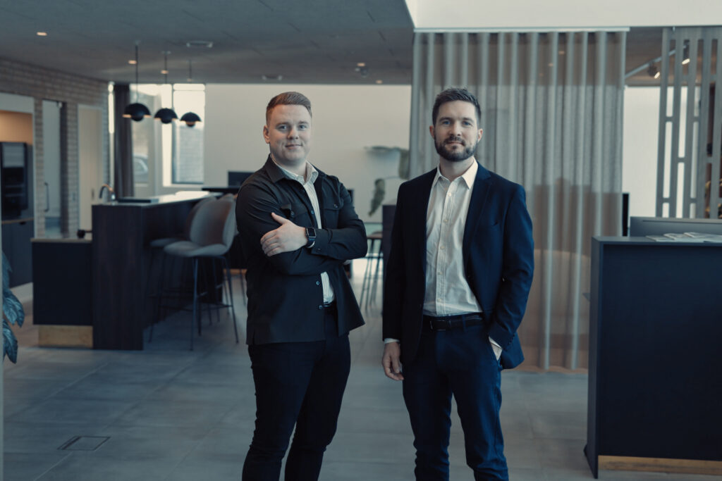 two men standing in a room