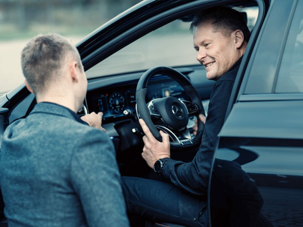 a man sitting in a car smiling